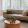 a well-lit living room with a couch and a table